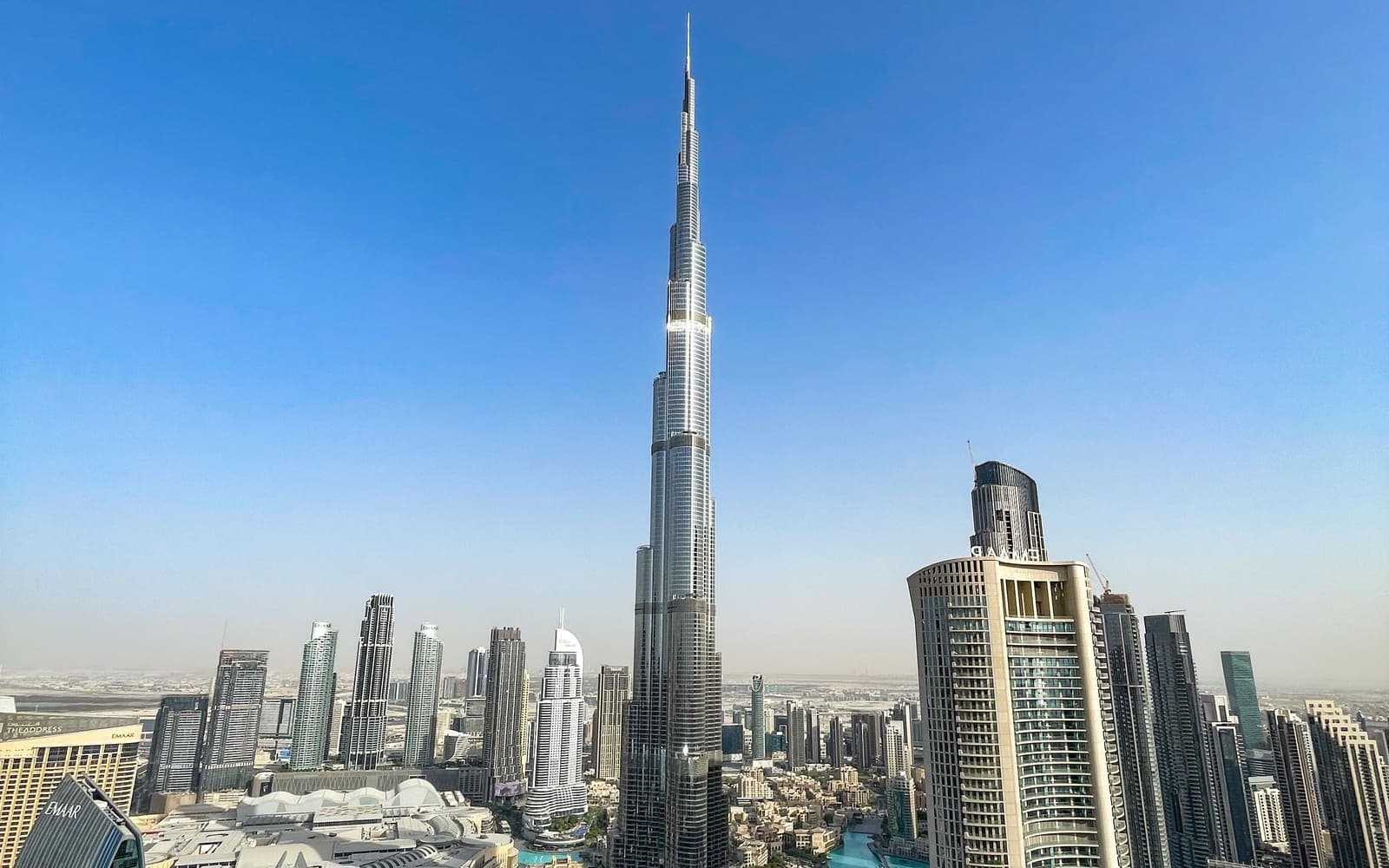 The Burj Khalifa rising above the Downtown Dubai skyline under a clear blue sky